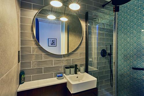 a bathroom with a sink and a mirror at Cinematique in Mosta