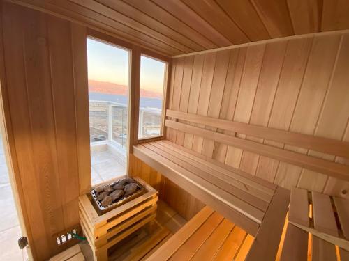an empty sauna with a bench and a window at Spa Eilat Mountain Lodge in Eilat