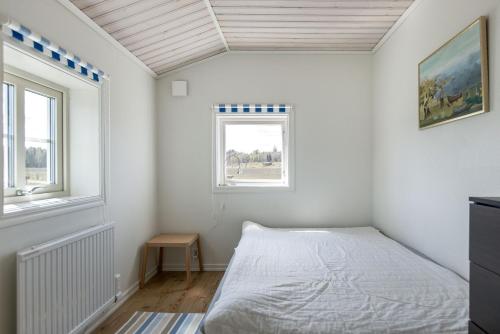 a bedroom with a bed and a window at Holiday house with terrace and views of Lake Hangasjon in Hamneda