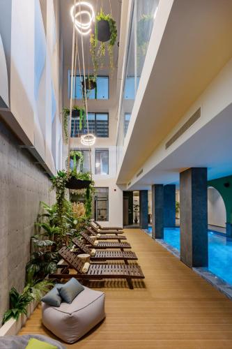 a hallway with a pool in a building at Minos Ambassador Suites & Spa - Adults only in Rethymno Town