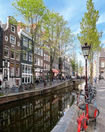 a group of bikes parked next to a canal at Facade Hotel Amsterdam in Amsterdam