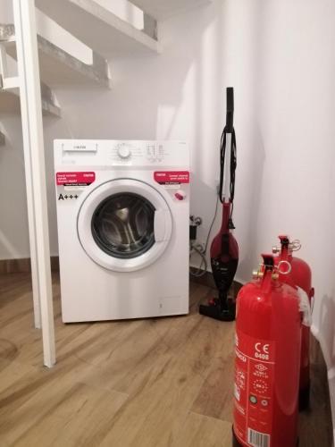 a washing machine in a room with a fire extinguisher at Orange&Lemon Villas Çamyuva in Kemer