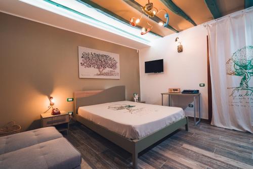 a bedroom with a bed and a couch at macchia mediterranea in Castellammare del Golfo