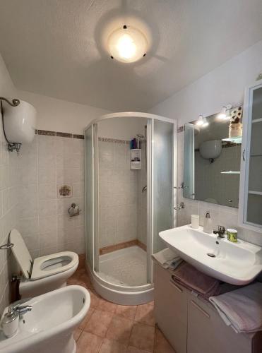 a bathroom with a shower and a toilet and a sink at A casa di Nicoletta in Tropea