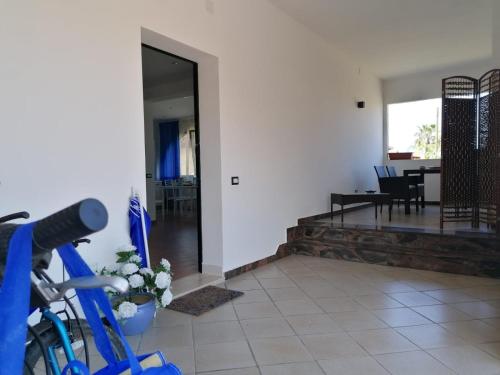 a bike parked in a room with a dining room at Momaliar House in Campofelice di Roccella