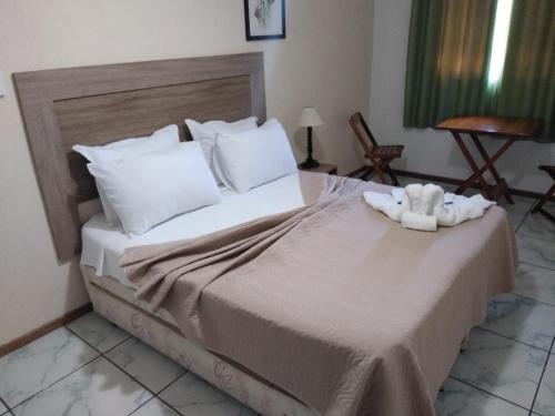 A bed or beds in a room at Pousada Sitio Sossego