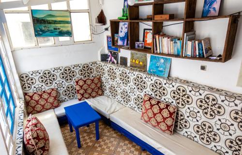 a living room with a couch and a table at White And Blue in Essaouira