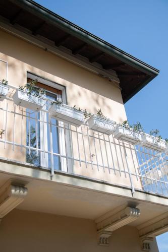 a balcony of a building with potted plants on it at Cà Miciàt in Cervia