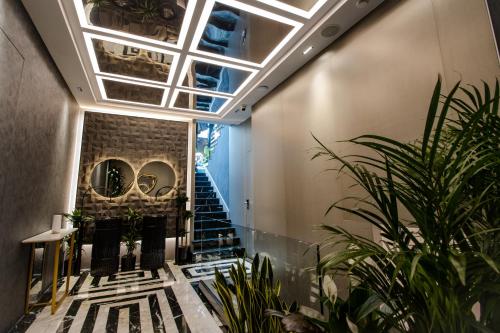 a hallway with plants and stairs in a building at The Crown Boutique Hotel & SPA in Tirana