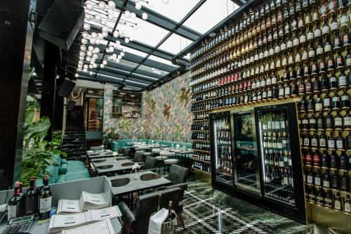 a restaurant with a bunch of tables and bottles of wine at The Crown Boutique Hotel & SPA in Tirana