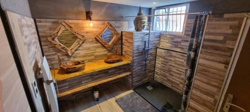 an overhead view of a bathroom with wooden walls at Rêves de vie, suite vue mer, grande piscine privée , spa privatif in Cassis