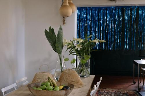 a dining room table with a bowl of fruit on it at InAweStays Holiday Homes in Cape Town