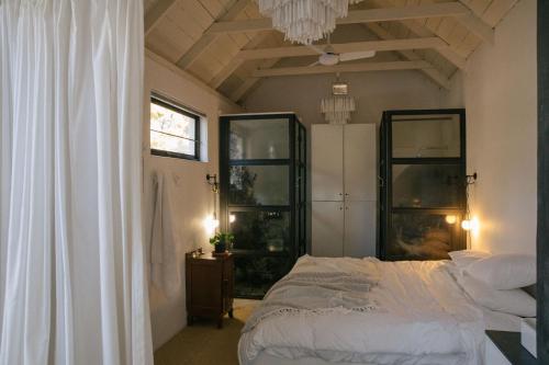 a bedroom with a bed and a chandelier at InAweStays Holiday Homes in Cape Town