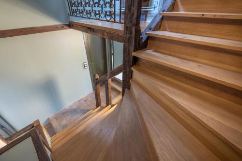 a staircase in a house with wooden floors at Break & Brut in Nogent-le-Roi