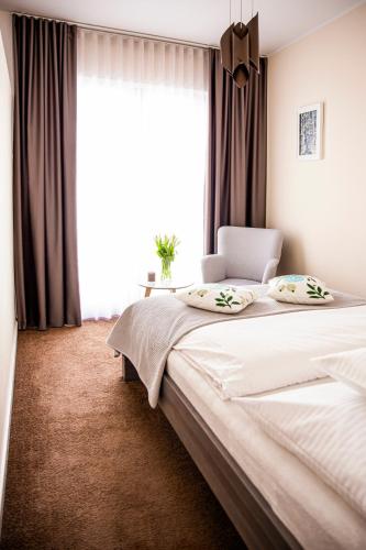 a bedroom with a large bed and a window at Apartament Bimba & Free Parking in Poznań