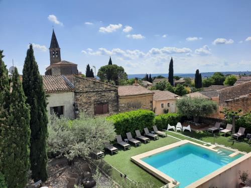an external view of a villa with a swimming pool at L'Ostal Saint Hilaire d'Ozilhan - Bed & Breakfast - Spa in Saint-Hilaire-dʼOzilhan