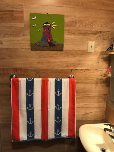a bathroom with a towel hanging on a wall at Combate Green House in Cabo Rojo