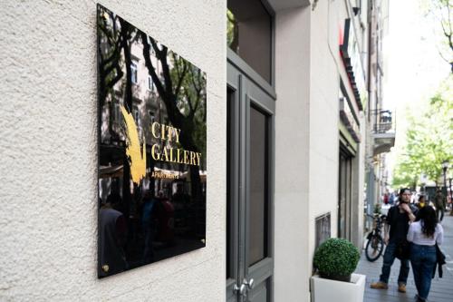 a sign for a city gallery on the side of a building at City Gallery Apartments in Trieste
