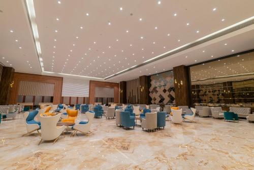 a large banquet hall with chairs and tables at Hotel Tip Top International Pune in Pune
