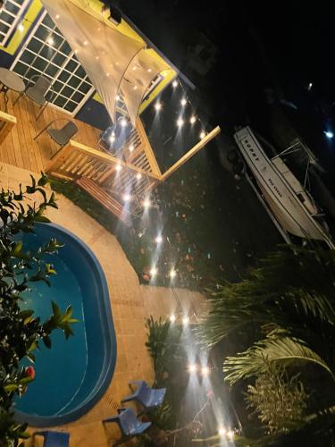 an overhead view of a swimming pool at night at Combate Green House in Cabo Rojo