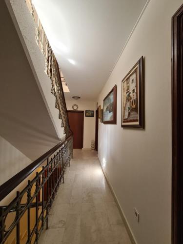 a hallway with a staircase with a stair railing at Beatrix Suites in Budva