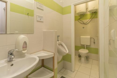 a bathroom with a sink and a toilet at Hostel Split Backpackers in Split