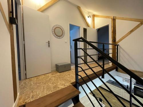 a staircase leading up to a room with white walls at Gîte moulin de Chaussac proche du Puy duFou in Saint-Laurent-sur-Sèvre