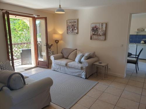 a living room with a couch and a table at Chez Louis Gites in Fumel