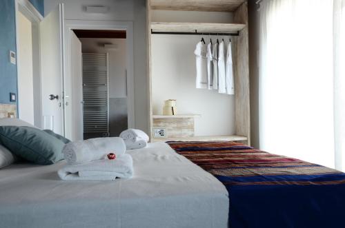 a bedroom with towels on top of a bed at Atmosfere Charme & Country in Udine