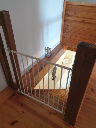 a spiral staircase with a metal railing in a room at Chez Louis Gites in Fumel