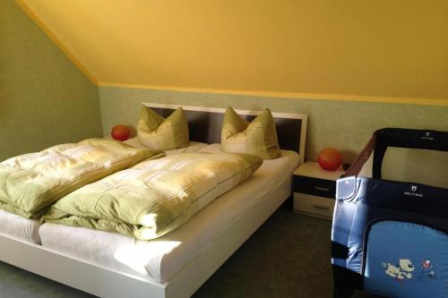 a bedroom with a bed and a blue suitcase at Ferienwohnungen Familie Lang in Pirna