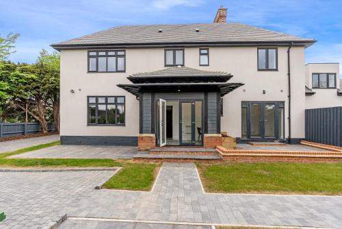 a white house with black windows and a driveway at Tailored Stays - Union lane in Chesterton