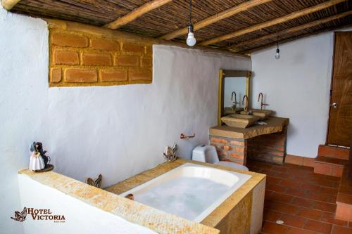 a bathroom with a large tub in a room at Hotel Victoria Barichara in Barichara