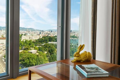 a rabbit sitting on a table in front of a window at Andaz Vienna Am Belvedere - a concept by Hyatt in Vienna