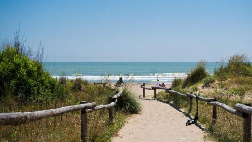 a path leading to a beach with people on it at New Campsite in Camping Ca' Savio in Cavallino-Treporti