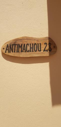 a wooden sign on a wall with the word antimaggression at Amalthea Guest House in Kos Town