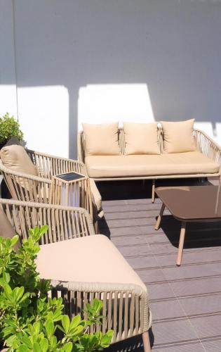 a patio with a couch and two chairs at Vila Garden Guesthouse in Lisbon