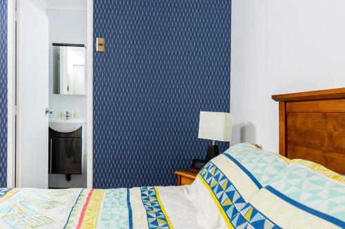 a bedroom with a bed and a bathroom with a sink at Cabañas Rio Rapel in Rapel