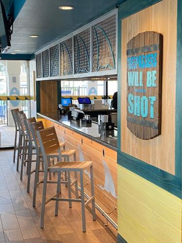 a row of stools at a bar in a restaurant at Margaritaville Beach Resort South Padre Island in South Padre Island
