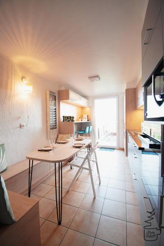 a kitchen with a table in the middle of a room at Studio Juliette in Stavelot