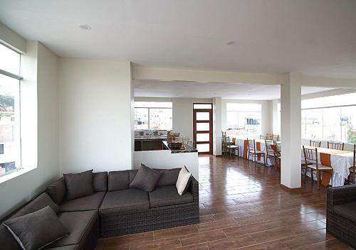 a living room with a couch and a table at HOSTAL CORAL in Ilo
