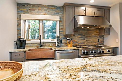 a kitchen with a sink and a stove at Villa's of Aspen by Snowmass Vacations in Aspen