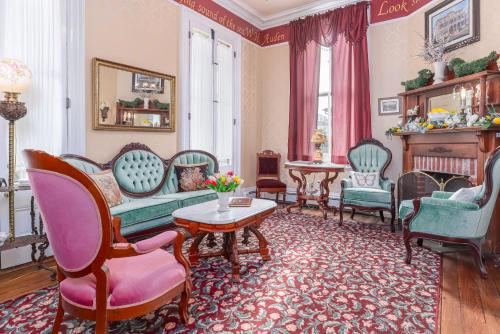 a living room with chairs and a couch and a table at Bedford Inn in Cape May