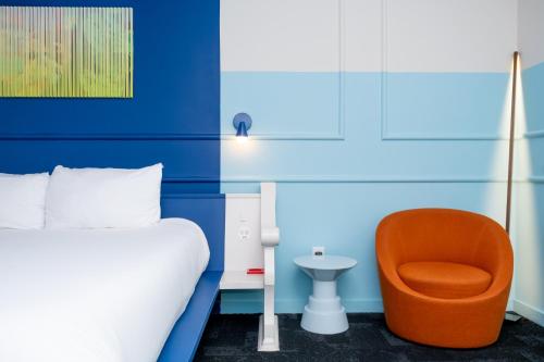 a bedroom with a bed and a chair at The Russell in Nashville