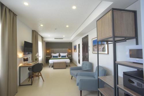 a hotel room with a bedroom and a bed at MAIA HOTEL SUITES in Tunis