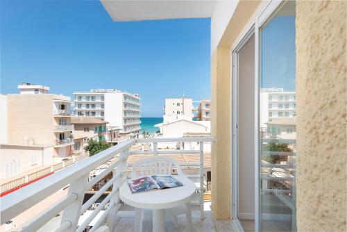 a balcony with a table and a view of the ocean at O7 Nordeste Playa in Can Picafort