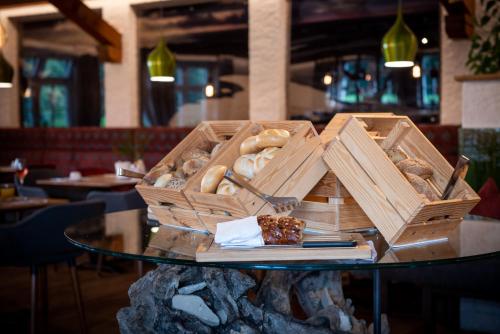 a table with two boxes of pastries on it at Hotel Bürglstein in St. Wolfgang