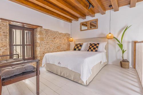 A bed or beds in a room at Sala Historical Luxury Suites