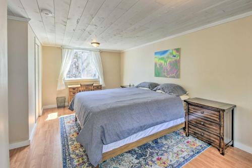 a bedroom with a bed and a table and a window at Lakefront Retreat with Large Yard and Boat Dock! in Hardwick