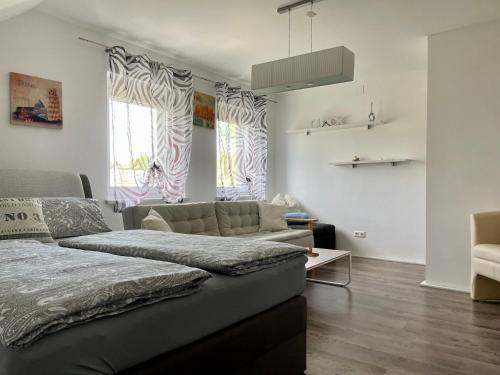 ein Wohnzimmer mit einem Bett und einem Sofa in der Unterkunft Ferienwohnung H&H Happy Holiday in Velden am Wörthersee